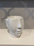 white ceramic wax burner in the shape of a head/face